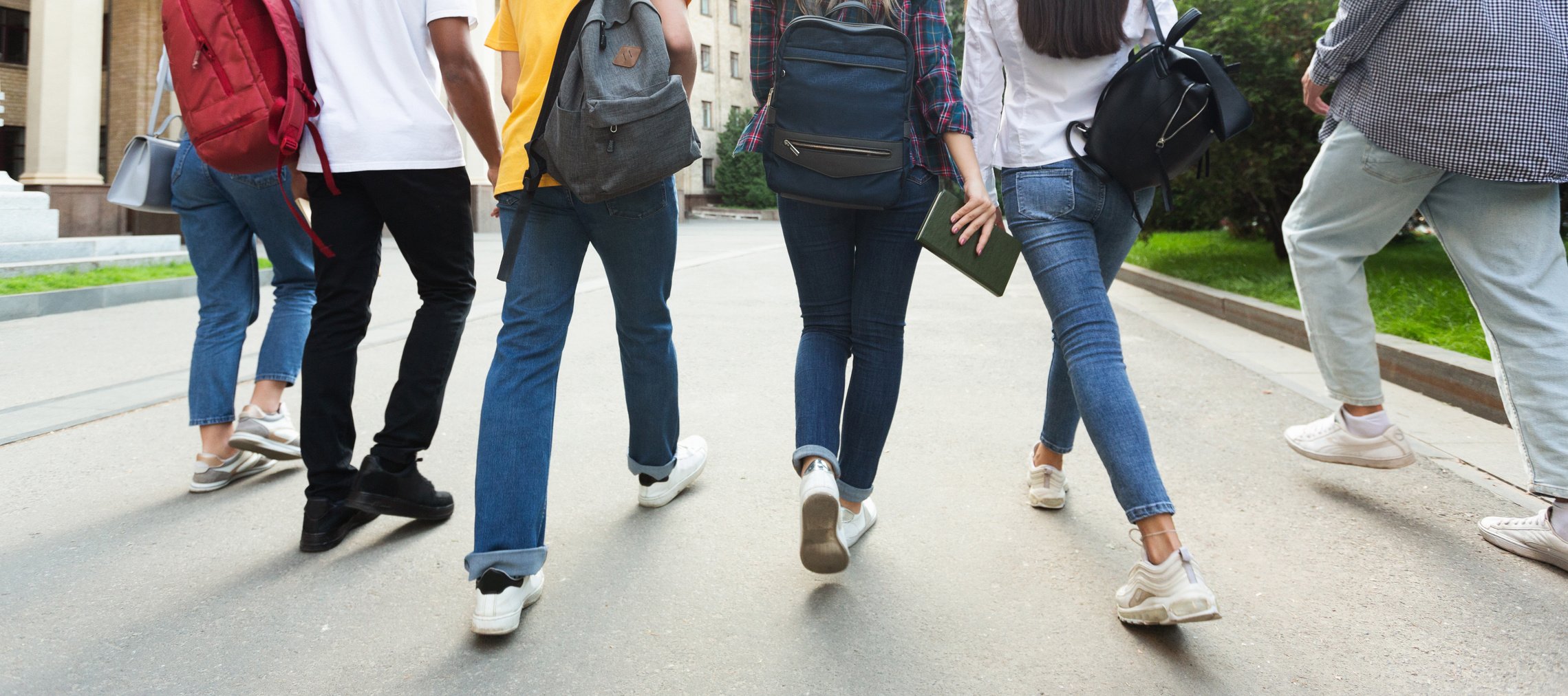 Unrecognizable teenage students in high school campus